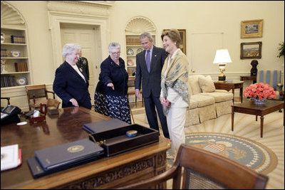 President George W. Bush and Laura Bush discuss some of the history of the Oval Office Agnes Chouteau, left, and Lorraine Stange both of Missouri Monday, May 2, 2005. The two women are recipients of the 2005 Preserve America Presidential Award. 