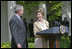 Laura Bush looks over to President Bush during a Rose Garden announcement honoring the 2005 Preserve America Presidential Awards Winners Monday, May 2, 2005. 