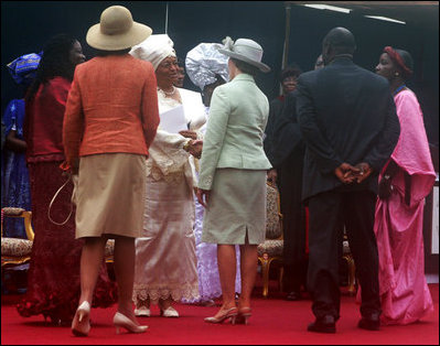 Mrs. Laura Bush, center, and U.S. Secretary of State Condoleezza Rice, left-foreground, congratulate Liberian President Ellen Johnson Sirleaf in Monrovia, Liberia, at her inauguration Monday, Jan. 16, 2006. President Sirleaf is Africa's first female elected head of state.