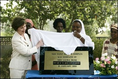 Mrs. Laura Bush helps unveil a plaque dedicating the Saint Kizito Complex at Saint-Mary's Catholic Church in Gwagwalada, Nigeria Wednesday, Jan. 18, 2006.