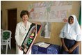Laura Bush admires a gift presented to her at the conclusion of her visit to the Model Secondary School in Abuja, Nigeria, January 18, 2006.