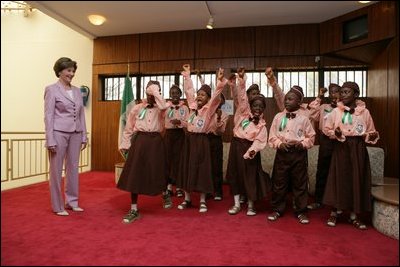 Laura Bush is greeted by a children's singing group at the National Center for Women's Development in Abuja, Nigeria, Wednesday, Jan. 18, 2006.