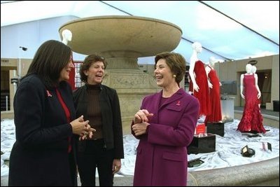 Laura Bush talks with Fern Mallis of 7th on Sixth, left, and Lynn Long, chief of Fashion Week production, after reviewing the designer dresses on display for "The Red Dress Project" in Bryant Park in New York City Friday, Feb. 14, 2003. "The Red Dress Project" is part of the Heart Truth campaign to raise awareness of heart disease as the number one killer of women. The dresses were created by 19 American designers and will tour the country through 2004. White House photo by Susan Sterner.