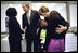 Sandy Anderson, wife of Lt. Col. Michael Anderson, one of the crew members lost aboard the Space Shuttle Columbia, talks with President George W. Bush at the NASA's Lyndon B. Johnson Space Center in Houston, Texas, Tuesday, Feb. 4, 2003. Laura Bush hugs Mrs. Anderson's daughters, Kaycee, 9, left, and Sydney, 11, after the memorial service. White House photo by Eric Draper.