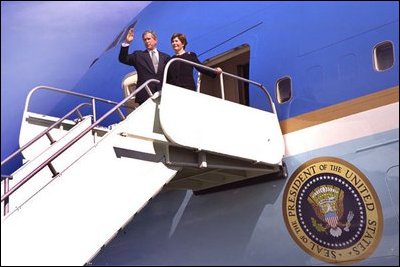 President George W. Bush and Laura Bush board Air Force One after attending a memorial service for the crew of the U.S. Space Shuttle Columbia at NASA's Lyndon B. Johnson Space Center in Houston, Texas, Tuesday, Feb. 4, 2003. White House photo by Eric Draper.