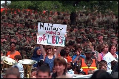 A military mom waits to greet Laura Bush with a special message during Mrs. Bush's visit to Ft. Jackson, South Carolina Tuesday, May 8, 2001. "President Bush also joins me in saying 'thank you' to our nation's military personnel for your service. We deeply appreciate the sacrifices you make for our nation...and the pride and honor you bring to our Armed Services," Mrs. Bush said during a Troop to Teachers rally.