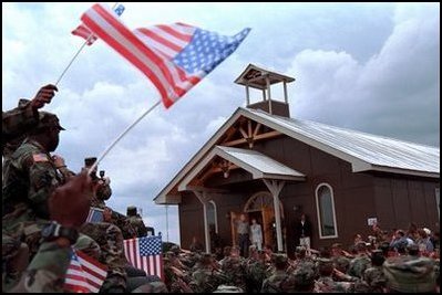 President George W. Bush and Laura Bush greet American troops at Camp Bondsteel in Kosovo Saturday, July 24, 2001.