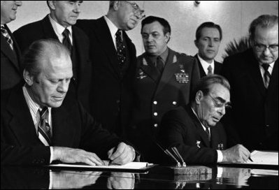 President Gerald R. Ford and Soviet General Secretary Leonid I. Brezhnev sign a joint communiqué Nov. 24, 1975, following their talks on the limitation of strategic offensive arms in Vladivostok, USSR. 