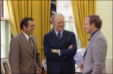 President Gerald R. Ford speaks with his Chief of Staff Donald Rumsfeld, left, and Rumfeld’s assistant Dick Cheney in the Oval Office, April 28, 1975.