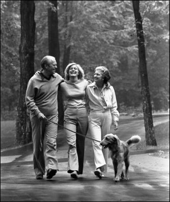 President Gerald R. Ford and Mrs. Betty Ford walk with their daughter, Susan, and family dog, Liberty, at Camp David Aug. 7, 1976.