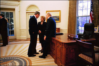 President George W. Bush talks with former President Gerald R. Ford and Betty Ford during a visit to the Oval Office July 16, 2003.