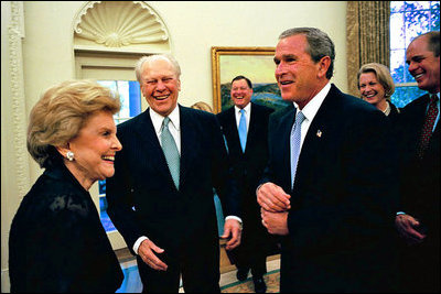 President George W. Bush laughs with former President Gerald R. Ford and Betty Ford in the Oval Office July 16, 2003.