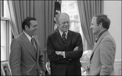 President Gerald R. Ford speaks with his Chief of Staff Donald Rumsfeld, left, and Rumfeld's assistant Dick Cheney in the Oval Office, April 28, 1975. White House photo by David Hume Kennerly.