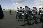 Soldiers parade by President George W. Bush and Laura Bush during an arrival ceremony at Glasgow Prestwick International Airport in Scotland July 6, 2005.