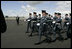 Soldiers parade by President George W. Bush and Laura Bush during an arrival ceremony at Glasgow Prestwick International Airport in Scotland July 6, 2005.
