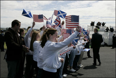 President George W. Bush and Laura Bush are greeted by ceremony and cheers upon their arrival at Glasgow Prestwick International Airport in Scotland July 6, 2005.