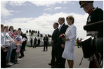 President George W. Bush and Laura Bush are greeted by ceremony and cheers upon their arrival at Glasgow Prestwick International Airport in Scotland July 6, 2005.