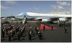 As President George W. Bush and Laura Bush disembarks Air Force One, a band is poised for their arrival at Glasgow's Prestiwick Airport, July 6, 2005.