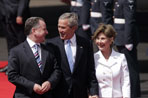 President George W. Bush and Laura Bush walk with Scotland's First Minister Jack McConnell   during the playing of national anthems upon their arrival at Glasgow's Prestiwick Airport, July 6, 2005.