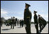 President George W. Bush and Laura Bush follow a Russian honor guard to place a wreath at the Monument to the Heroic Defenders of Leningrad, Friday, July 14, 2006, in St. Petersburg, Russia.