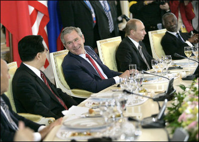 President George W. Bush talks with Chinese President Hu Jintao, left, during a luncheon with world leaders during the G8 Summit at the Konstantinovsky Palace Complex Monday, July 17, 2006 in Strelna, Russia. Also pictured is Russian President Vladimir Putin, and South African President Thabo Mbeki, far-right.