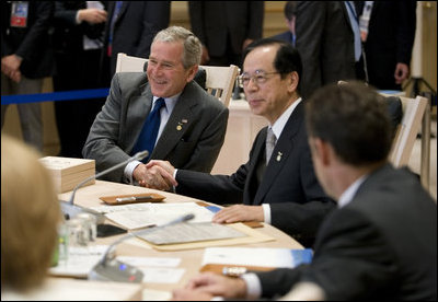 President George W. Bush exchanges handshakes with Prime Minister Yasuo Fukuda of Japan, Tuesday, July 8, 2008, as the G-8 leaders began their morning working session at the Windsor Hotel Toya Resort and Spa in Toyako, Japan.