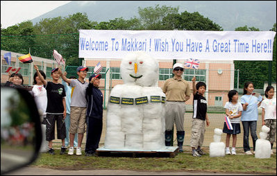 Flag-waving youngsters and a snowman welcome the G-8 Spouses to Makkari Tuesday, July 8, 2008, where they visited a farmer’s market and participated in a luncheon hosted by Mrs. Kiyoko Fukuda, spouse of Japan’s Prime Minister Yasuo Fukuda, host of the 2008 G-8 Summit.