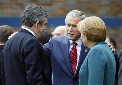 President George W. Bush speaks with Prime Minister Gordon Brown, United Kingdom, and Chancellor Angela Merkel, Germany, during the final day of the G-8 Summit Wednesday, July 9, 2008, in Toyako, Japan.