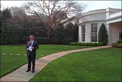 White House Chief of Staff Andy Card watches President George W. Bush depart from the South Lawn April 12, 2001 