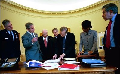 President George W. Bush and senior advisors look at a map of Iraq on the Resolute Desk in the Oval Office April 2, 2003. Pictured, from left, are Gen. Richard Myers, Vice President Dick Cheney, Chief of Staff Andy Card, Defense Secretary Donald Rumsfeld, National Security Advisor Dr. Condoleezza Rice and Defense Under Secretary Paul Wolfowitz.