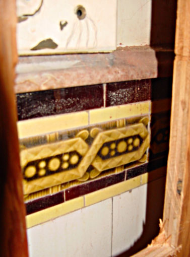 Detail of the decorative wall tile border and marble cap hidden behind plywood.