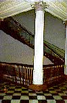 Photo of cast iron column and marble floor with a granite staircase in the background (1991, Office of Administration, EOP)