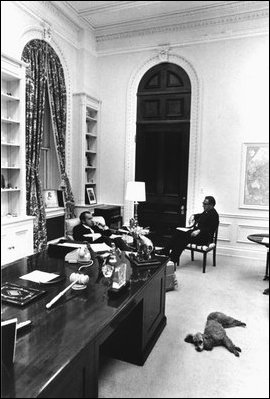 President Richard Nixon (left behind desk), his poodle Vicky, and Secretary of State Henry Kissinger in room 180 in November 1971.