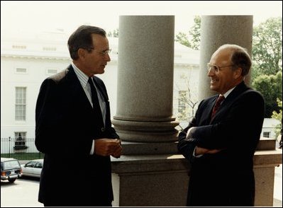 Conferring on the Navy steps of the EEOB are President George H.W. Bush and Secretary of Defense Richard B. Cheney in 1991.
