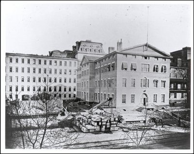 West Wing shortly after its groundbreaking showing the original State, War, and Navy Building still in place before its demolition, ca. 1883.
