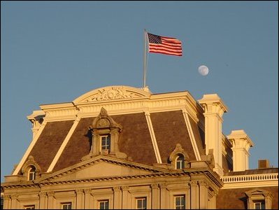 The Eisenhower Executive Office Building's west center pavilion roof as the sun sets and the moon rises.