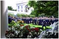 President George W. Bush approached the podium for the presentation ceremony of Commander-in-Chief's Trophy to the Air Force Academy football team in the Rose Garden Friday, May 17, 2002. "I'm proud of what this group of Americans have done on the football field. No more proud than those who wear the blue, I might add. And I'm proud of your commitment to our country," said the President in his address. 