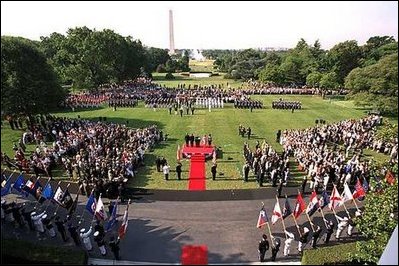 President George W. Bush and Laura Bush stand with visiting President Aleksander Kwasniewski of Poland and his wife, Jolanta Kwasniewska, during the State Arrival Ceremony on the South Lawn Wednesday, July 17, 2002.