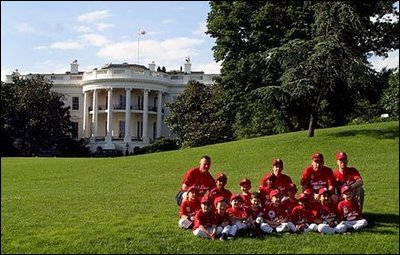 The Fort Belvoir Little League Braves of Fort Belvoir, Va., pose for a team photo after playing tee ball with the Naval Base LIttle League Yankees of Norfolk, Va., on the South Lawn Sunday, June 22, 2003. 