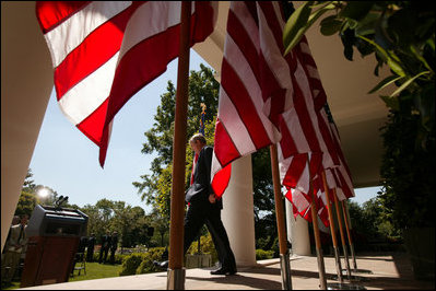 President George W. Bush walks to the podium in the Rose Garden before the start of a morning press availability Tuesday, May 31, 2005.