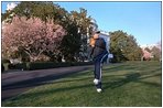 President Bush warms up his pitching arm under the glow of Magnolia trees on the South Lawn April 3, 2001. 