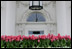 The North Portico entrance to the White House is decorated with bright pink tulips beneath the ornate hanging lamp April 11, 2007. White House photo by Shealah Craighead 