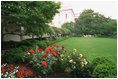 Pictured is the Rose Garden viewed from the West Wing. To the left is the West Colonnade. 