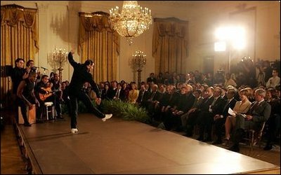 President George W. Bush and Laura Bush watch the performance of Joaquin Cortes as he dances to a quintet of Flamenco musicians during a Hispanic Heritage Month celebration in the East Room of the White House Wednesday, Sept. 15, 2004.