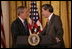 President George W. Bush thanks U.S. Commerce Secretary Carlos Gutierrez for his introduction in the East Room of the White House, Friday, Oct. 7, 2005, as President Bush prepares to address remarks in celebration of Hispanic Heritage Month. President Bush also honored recipients of the President's Volunteer Service Awards at the event.