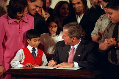 President George W. Bush signs an executive order creating the President's Advisory Commission on Educational Excellence for Hispanic Americans Oct. 12, 2001. He signed the order during the White House reception celebrating Hispanic Heritage Month.