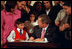 President George W. Bush signs an executive order creating the President's Advisory Commission on Educational Excellence for Hispanic Americans Oct. 12, 2001. He signed the order during the White House reception celebrating Hispanic Heritage Month.