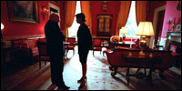 Vice President Dick Cheney and Dr. Condoleezza Rice speak in the Red Room before a press availability by the President of Pakistan Feb. 13, 2002. In contrast to the large East Room, the smaller Red Room has provided a place for quiet conversation over the years.