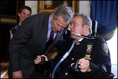 President George W. Bush speaks with NYPD Officer Steve McDonald in the Blue Room April 10, 2002. 