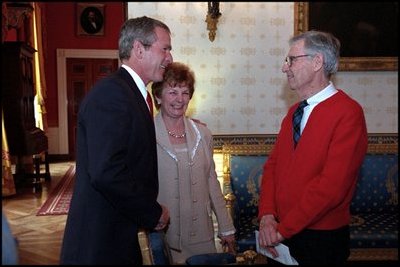 President George W. Bush greets Fred Rogers of Mister Rogers Neighborhood in the Blue Room before an early childhood education event in the East Room April 3, 2002. 
